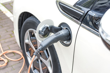 Electric car charging on a street