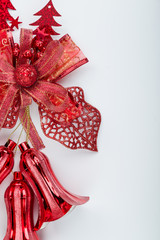 Red christmas bell decoration hanging on white 