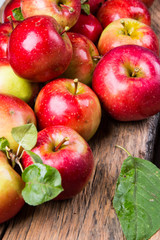 Apples on wooden table over autumn bokeh background
