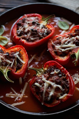 Stuffed bell peppers with tomato sauce and parmesan, close-up