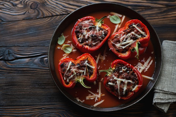 Baked bell peppers stuffed with ground beef meat in a frying pan