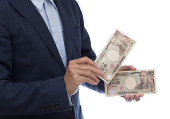 Businessman hand holding Japanese Yen