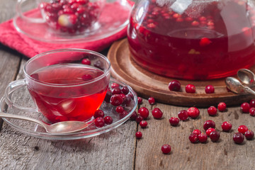 Cranberry tea in a glass cup and teapot