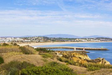 background view of the city of Lagos in Portugal, dock, cape and the ocean