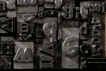 Metal Lettrpress Types.
A background from many historic typographical letters in black and white with white background.