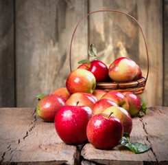 Apples on wooden table over autumn bokeh background