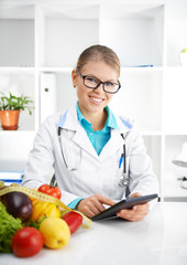 Healthy nutrition. Cheerful female dietitian typing treatment to patient via internet.  