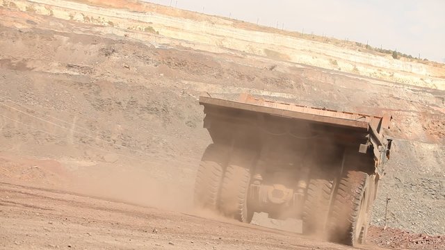 Quarrying, machine. A large mining truck transports ore. Dumper.