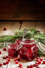 Winter cranberry sauce in glass jars with fresh cranberries, dec
