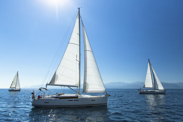 Naklejka na ściany i meble Sailing regatta. Sailing in the wind through the waves. Luxury yachts.