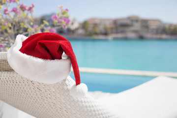Red Santa Claus hat by the pool