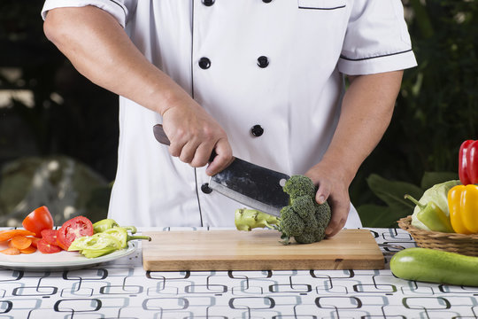 Chef cutting broccoli