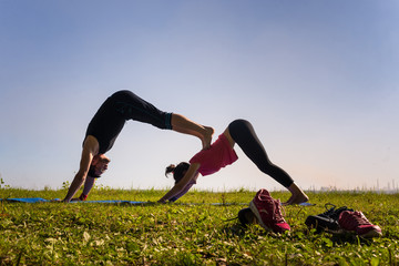 Fototapeta premium beautiful couple doing acro yoga on the beach