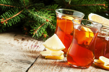 Hot tea with ginger, honey and lemon in oriental glasses on the