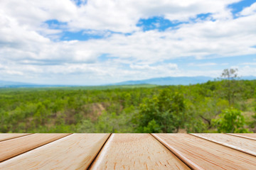Fototapeta na wymiar Empty Wooden deck table over blur nature background