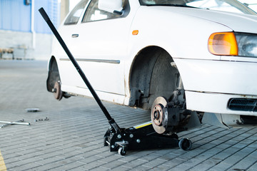 car jack to lift for tire (shallow DOF) © smspsy