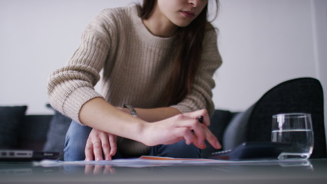 4K Attractive woman calculating and feeling a bit anxious about something