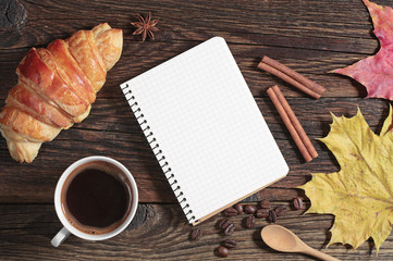 Naklejka na ściany i meble Opened notepad, croissant and coffee