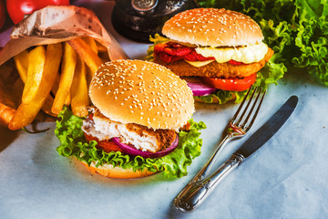 Fish burger with fries rural areas on white paper in a pub