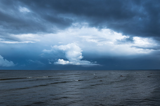 Fototapeta White cloud and dark sea.