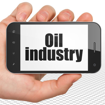 Industry concept: Hand Holding Smartphone with Oil Industry on display