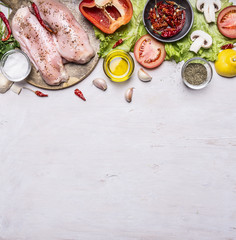 Ingredients for cooking a turkey breast On a cutting board pepper oil tomato chili lemon lettuce mushrooms salt and spices laid out horizontally space for text banner for the web site border