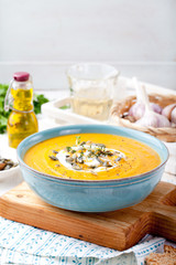 Roasted pumpkin and carrot soup with cream . 