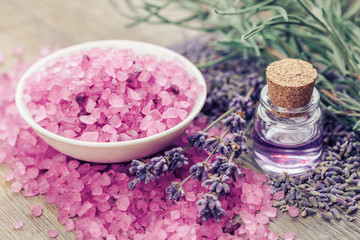 Fototapeta na wymiar Aromatic sea salt, bottle of essential oil and lavender flowers.