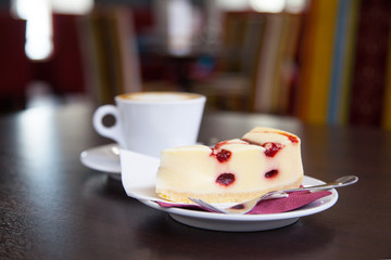 Cheesecake and coffee cup on a table in a cafe