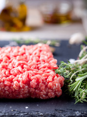 Minced meat on a slate stone black board.