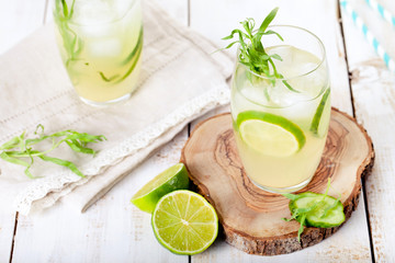 Lime cucumber lemonade cocktail on a white table