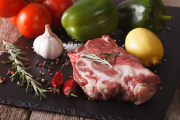 raw pork neck and vegetables close-up on board. horizontal
