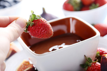 Chocolate fondue with fresh berries, close up