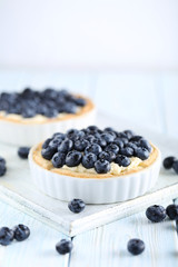 Blueberry tart on blue wooden table