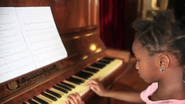 African girl playing piano