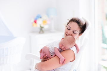 Obraz na płótnie Canvas Mother and newborn baby in white nursery