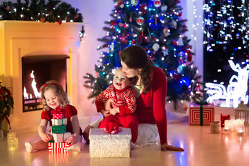 Fototapeta na wymiar Mother and children at home on Christmas eve