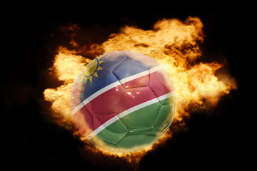 Fototapeta premium football ball with the flag of namibia on fire