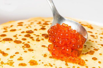 some pancakes on the white plate with red caviar