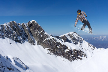 Flying snowboarder on mountains