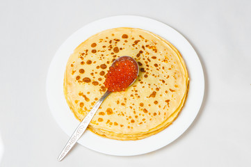 some pancakes on the white plate with red caviar