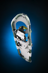Modern snowshoe under view isolated on gradiant black and blue