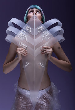 Young, thin, pale girl with tirquoise blue-purple hair ,with pageboy hairstyle, purple make up, in futuristic ,plastic ,white ,transparent costume 
