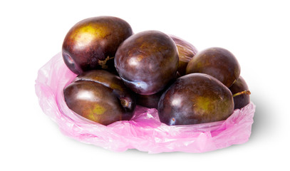 Whole violet plums in plastic bag