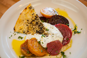 tri-color heirloom beet salad with lemon tahini sauce on za'atar