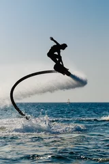 Washable wall murals Water Motor sports Silhouette of a hover board rider