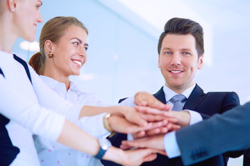 Business people with their hands together in a circle