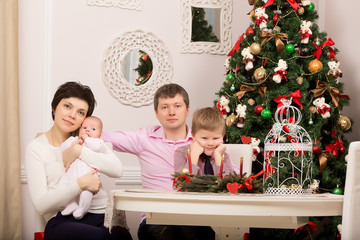 Family at the holiday table. Tree. New year