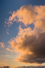 Fototapeta premium Cloudy sky at sunset or sunrise, orange light