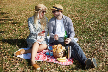 Beautiful Young Couple Having Picnic in Countryside. Happy Famil